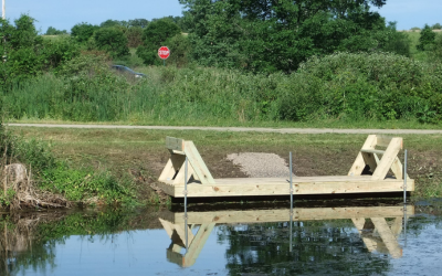 Eagle Scout construction project: two Leopold benches on a deck overlooking a body of water. 