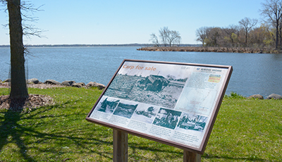 Interpretive panels talking about carp harvesting along the shore of Lake Kegonsa